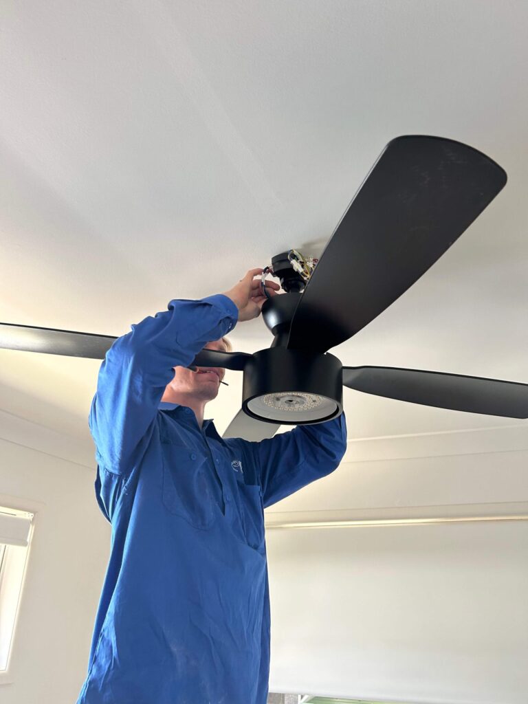 Licensed electrician repairing safety switch in North Brisbane switchboard