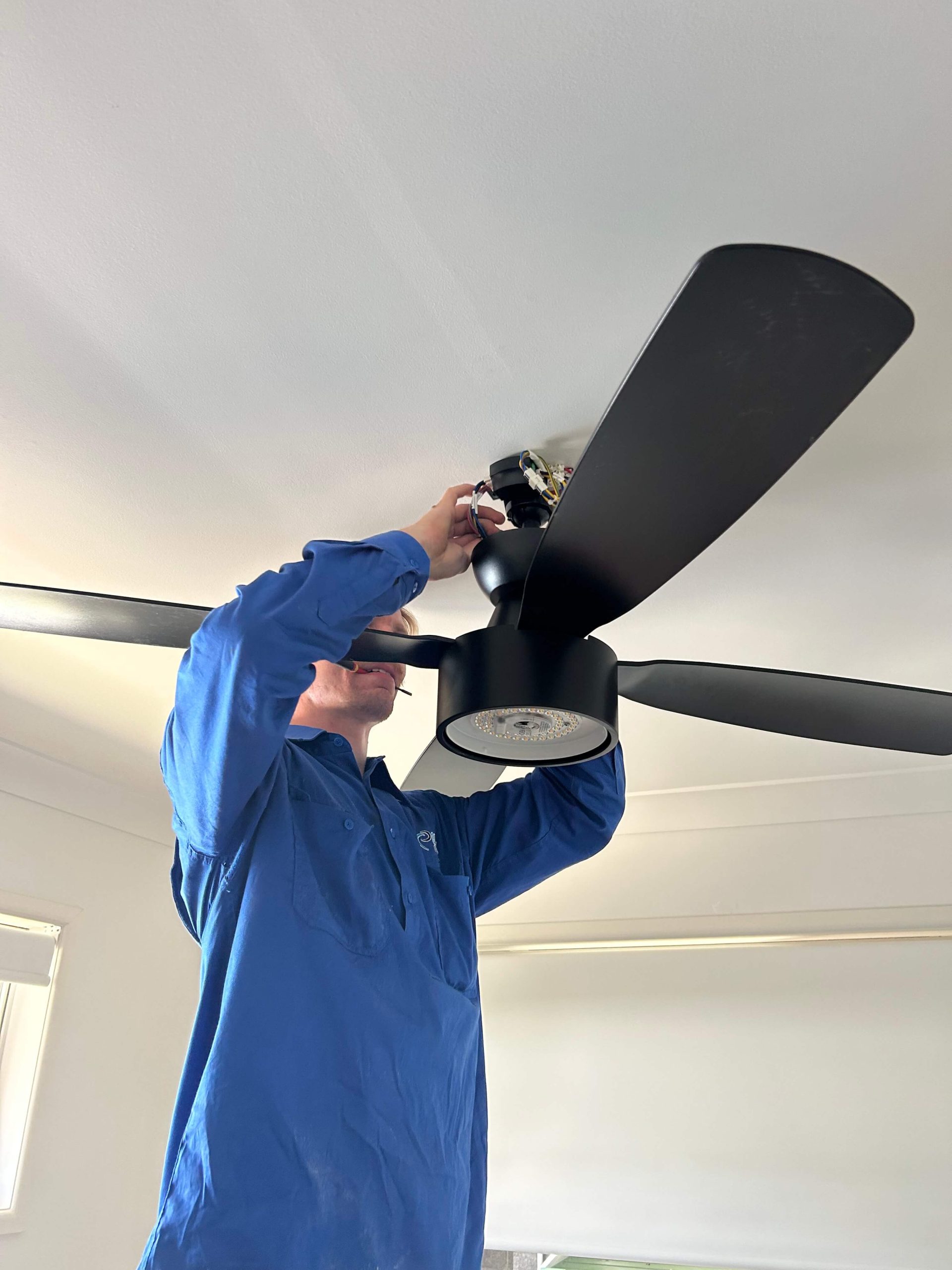 Licensed electrician repairing safety switch in North Brisbane switchboard