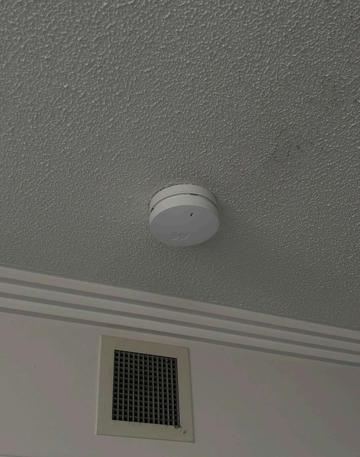 Photoelectric smoke alarm installed on the ceiling of a North Brisbane home by Connex Electrical